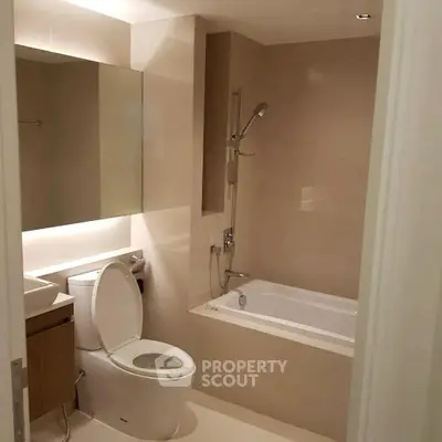 Modern bathroom with bathtub and sleek fixtures in a contemporary apartment.