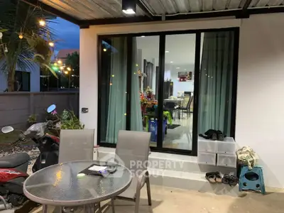 Charming patio with glass doors leading to a cozy interior, perfect for relaxing evenings.