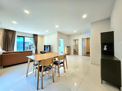 Spacious modern living room with dining area and large windows for natural light.