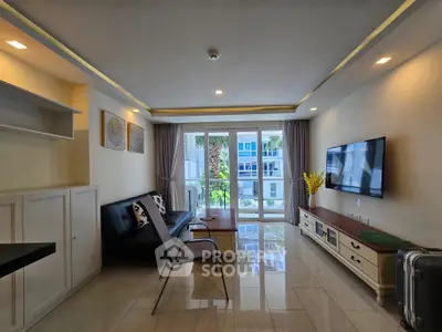 Modern living room with sleek furniture and large windows offering a bright, airy ambiance.