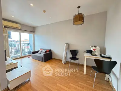 Spacious living room with modern decor and large window offering city views.
