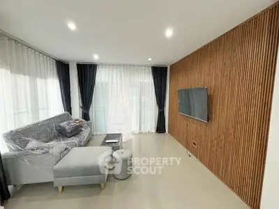 Modern living room with sleek wood paneling and cozy furniture