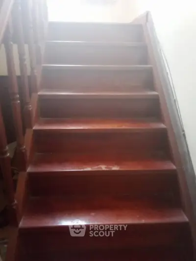Wooden staircase with classic railing in a cozy home setting
