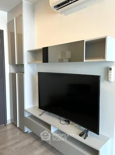 Modern living room with sleek TV unit and air conditioning, perfect for contemporary living.