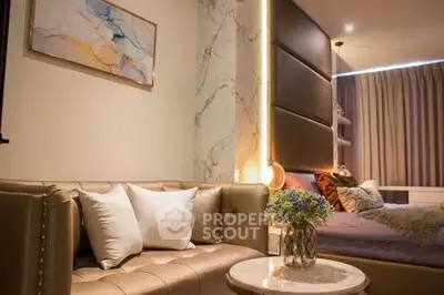 Luxurious modern bedroom with elegant decor and cozy seating area, perfect for relaxation.
