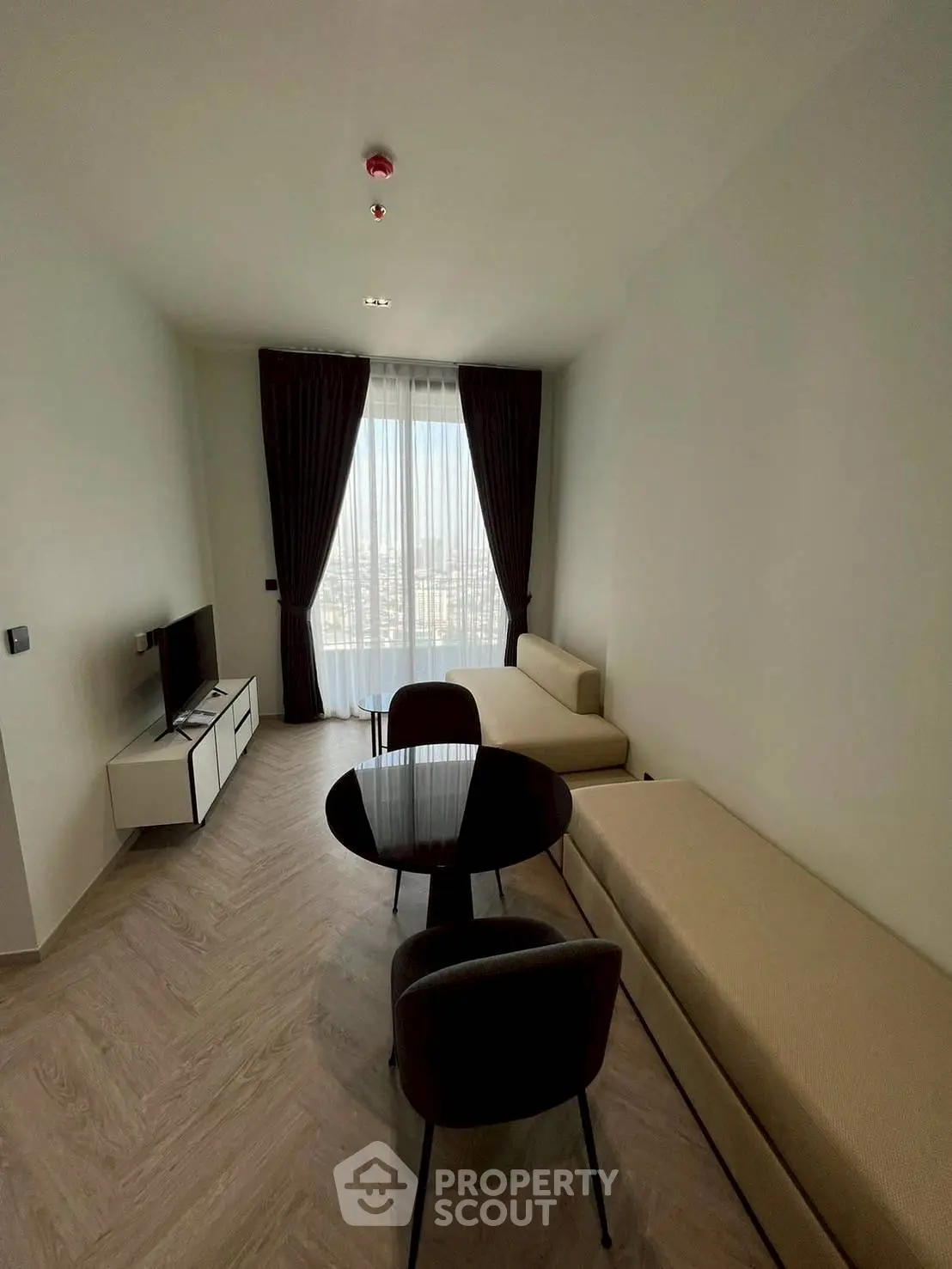 Modern living room with minimalist furniture and large window view