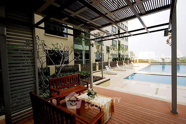 Luxurious poolside area with elegant seating and modern design, perfect for relaxation and leisure.
