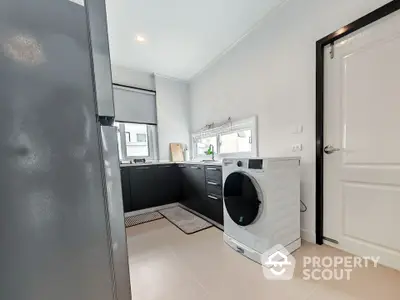 Modern kitchen with sleek appliances and ample natural light