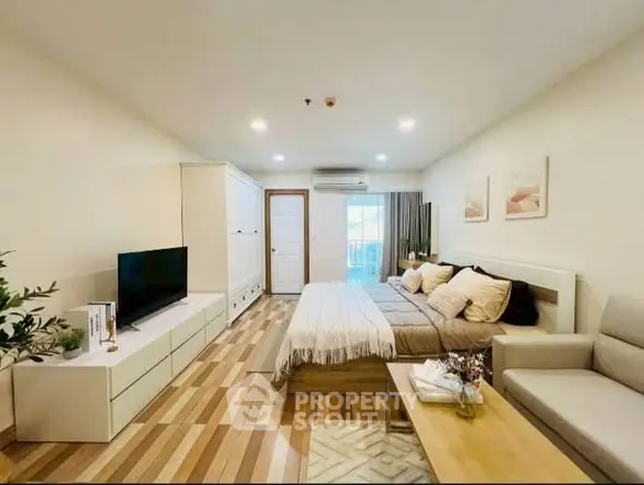 Spacious modern bedroom with stylish decor and natural light