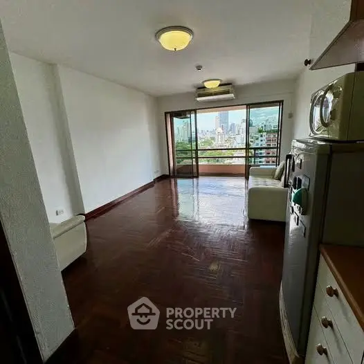 Spacious living room with city view and elegant parquet flooring