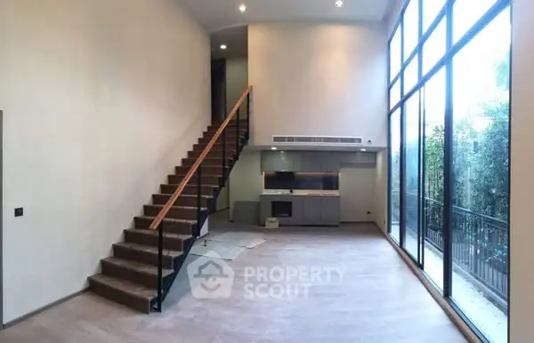 Spacious modern living room with high ceilings and large windows