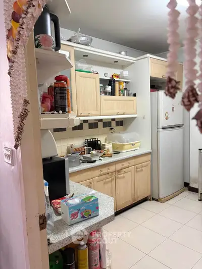 Cozy kitchen with wooden cabinets and modern appliances in a compact layout