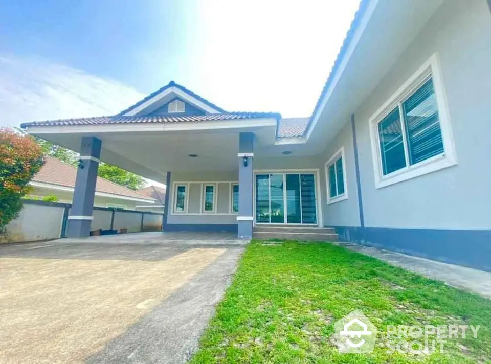 Charming single-story home with spacious driveway and lush green lawn