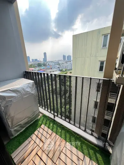Charming balcony with city view and wooden deck flooring, perfect for relaxation.