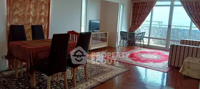 Spacious living room with elegant decor and large windows offering stunning views.