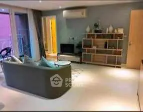 Spacious living room with modern decor and balcony access