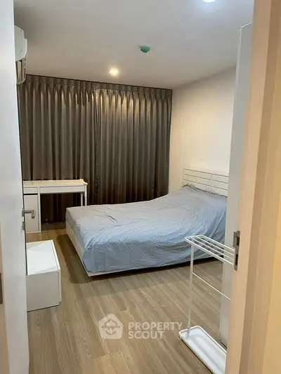 Cozy bedroom with modern furnishings and wooden flooring