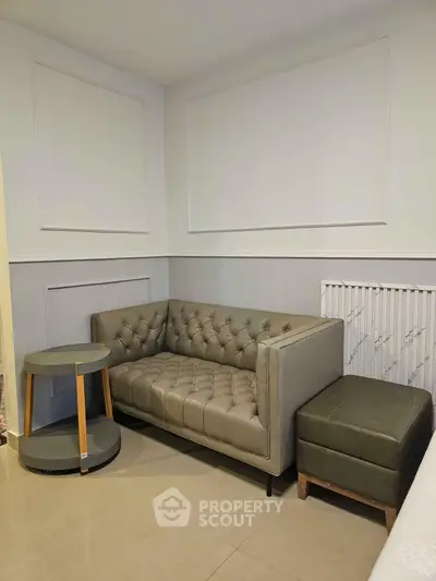Stylish modern living room with elegant leather sofa and chic side table, perfect for cozy relaxation.