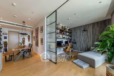 Modern open-plan living room with stylish decor and home office area.