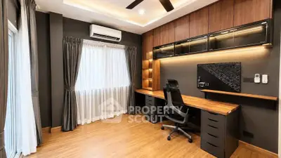 Modern study room with sleek wooden desk and ergonomic chair, featuring elegant lighting and large window.