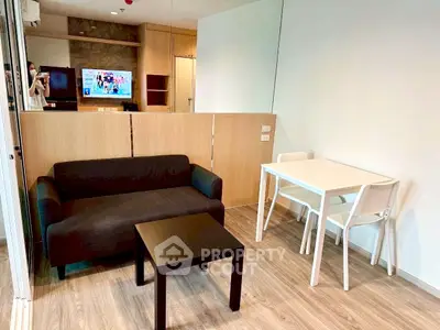 Modern living room with sleek furniture and wooden accents in a cozy apartment setting.