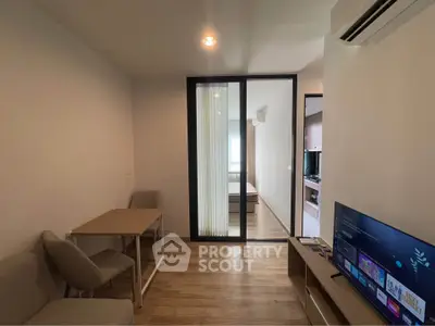 Modern apartment interior with open living space and bedroom view