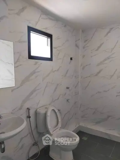 Modern bathroom with marble walls and sleek fixtures