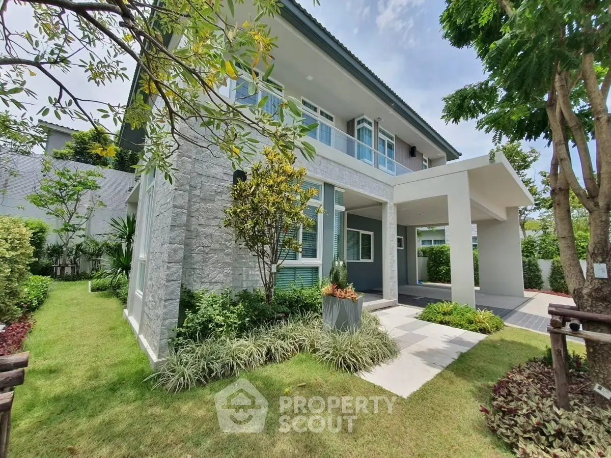 Modern two-story house with lush garden and contemporary design