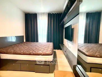 Modern bedroom with sleek design, featuring a large bed, wall-mounted TV, and stylish curtains.