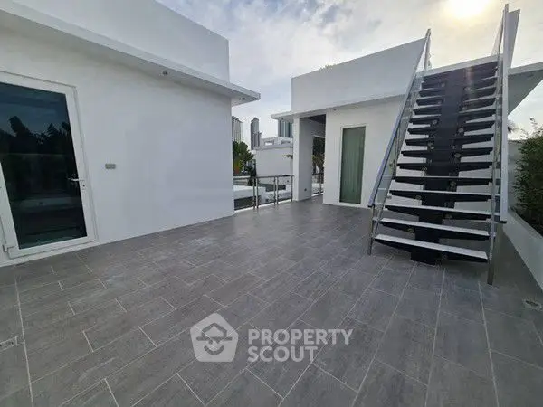 Modern rooftop terrace with sleek design and city views, perfect for outdoor relaxation and entertainment.