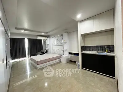 Spacious modern studio apartment with sleek design and natural light
