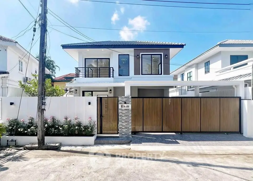 Modern two-story house with sleek design and spacious driveway in a serene neighborhood.
