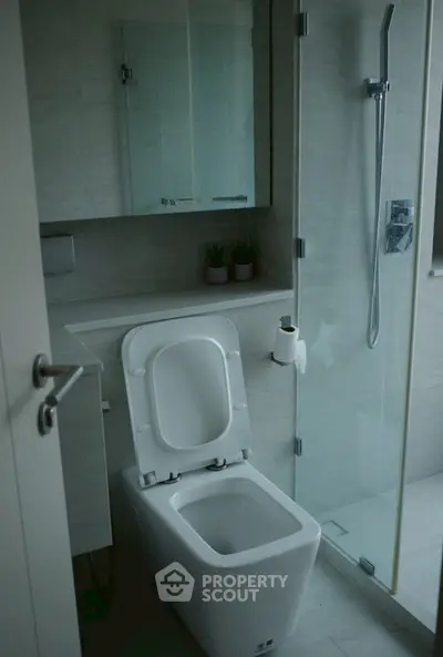 Modern bathroom with sleek design, glass shower, and contemporary fixtures.