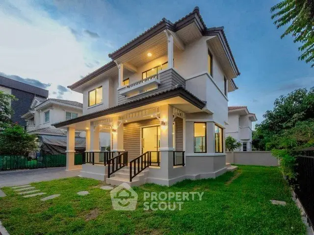 Stunning two-story house with lush green lawn and modern architecture, perfect for family living.