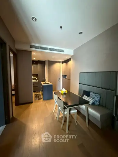 Modern open-plan kitchen and dining area with stylish decor and wooden flooring.