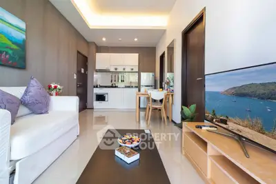 Modern living room with open kitchen, sleek furniture, and vibrant decor in a stylish apartment.