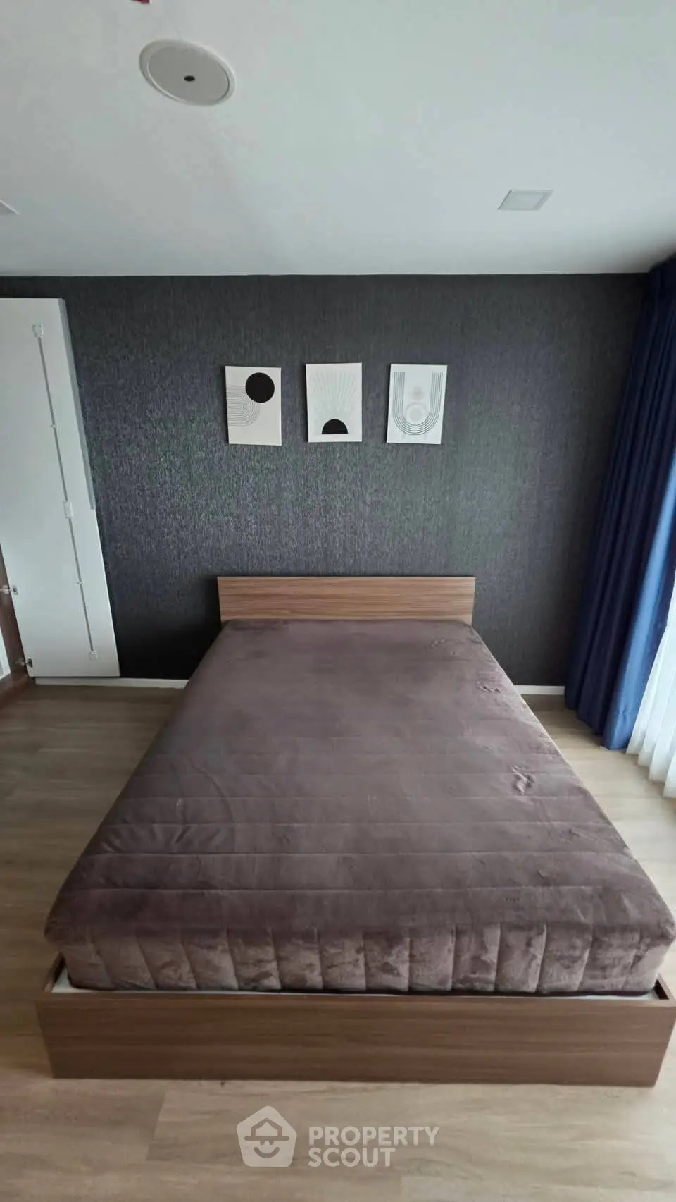 Modern bedroom with stylish decor and cozy bed in contemporary apartment.