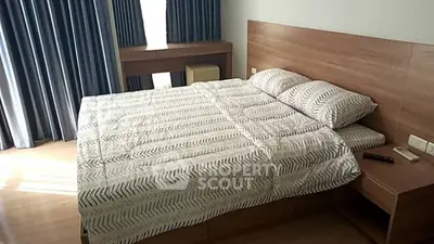 Spacious bedroom with modern decor and natural light