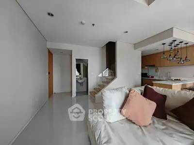 Modern living room with open kitchen and stylish staircase