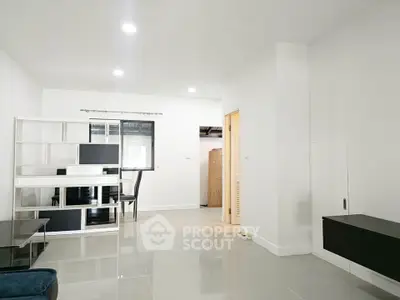 Spacious modern living room with sleek furniture and bright lighting, perfect for contemporary living.