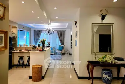 Elegant open-layout living room with modern kitchen and stylish decor