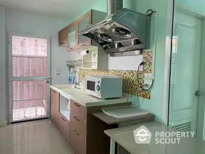 Modern kitchen with sleek cabinetry and stainless steel range hood