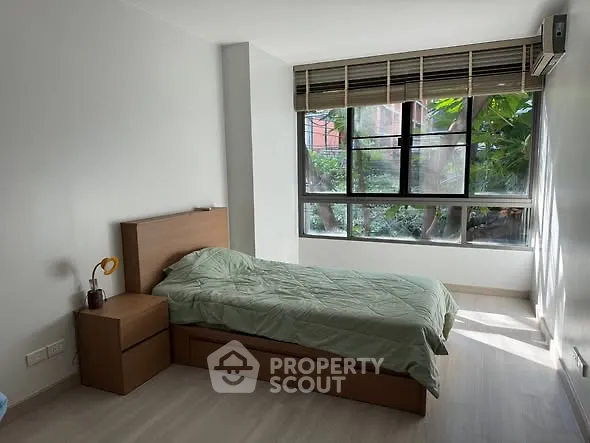 Bright bedroom with large window and modern furnishings