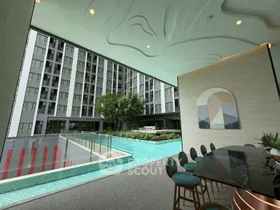 Modern apartment building with pool and stylish seating area, perfect for luxury living.