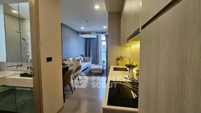 Modern apartment with sleek kitchen and cozy living area, perfect for urban living.