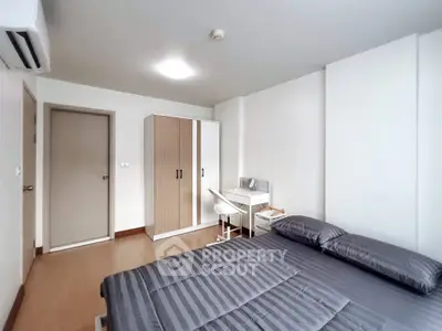 Modern bedroom with sleek furniture and ample storage in a stylish apartment.