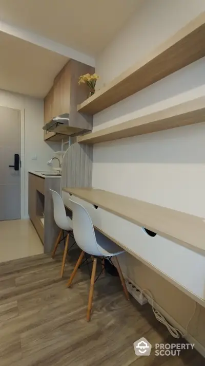 Modern kitchen with sleek wooden shelves and dining area