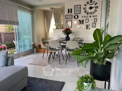 Chic modern living room with stylish dining area, large windows, and elegant decor for a cozy home ambiance.