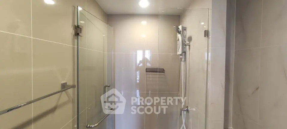 Modern bathroom with glass shower enclosure and sleek fixtures