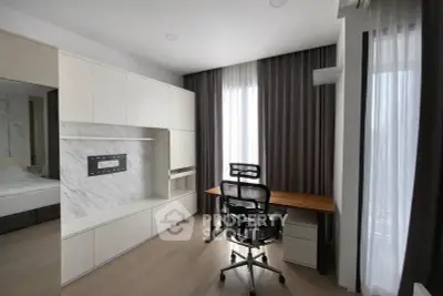 Modern study room with sleek desk and ergonomic chair, featuring floor-to-ceiling windows and elegant curtains.
